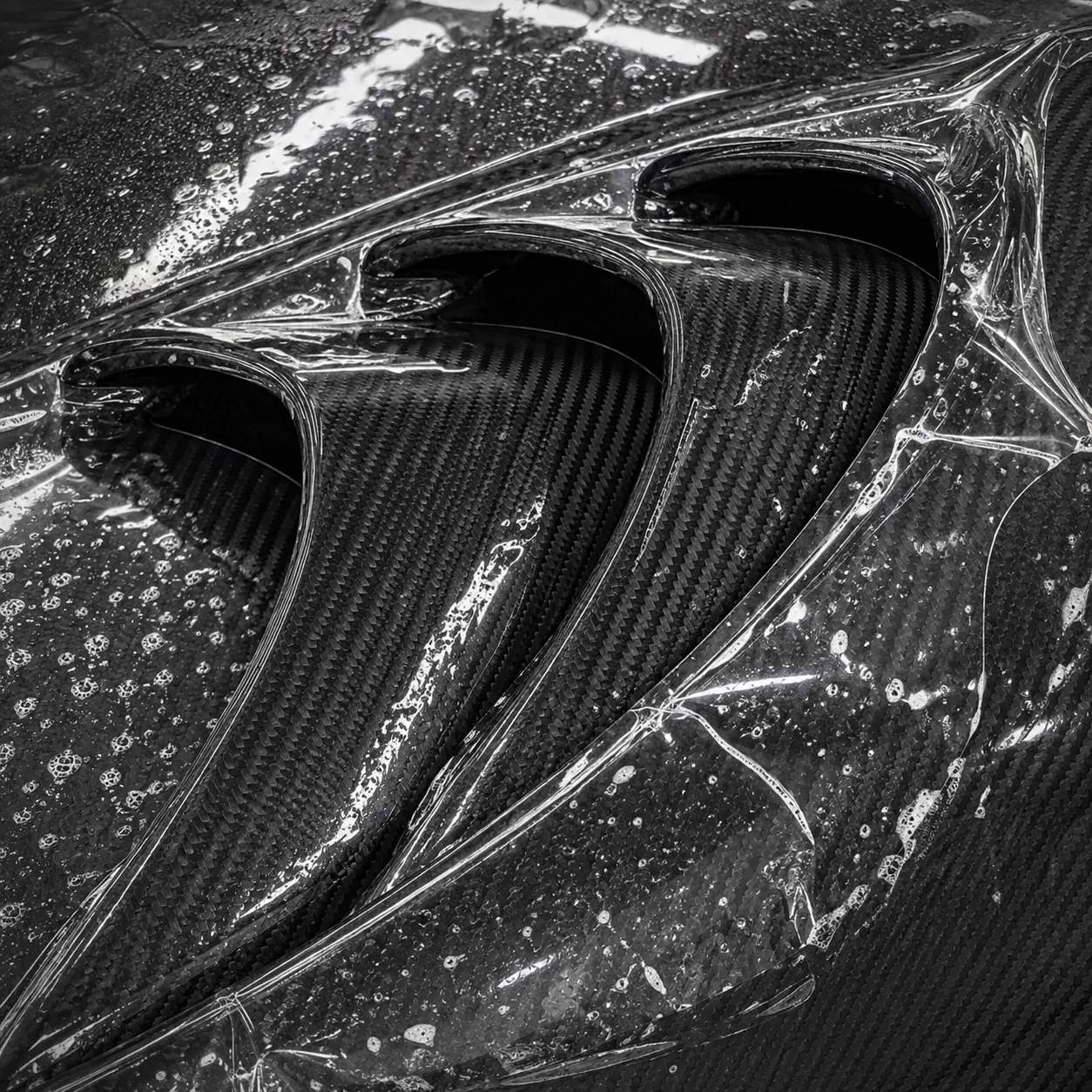 Paint protection film being squeegeed onto a Porsche front end in Avon, Ohio