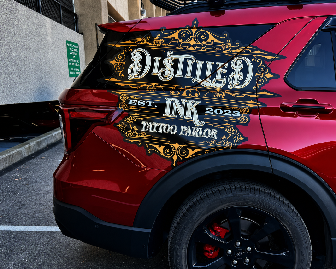 Custom printed perforated rear window decal on a red SUV by CustomsByAli in Elyria, OH