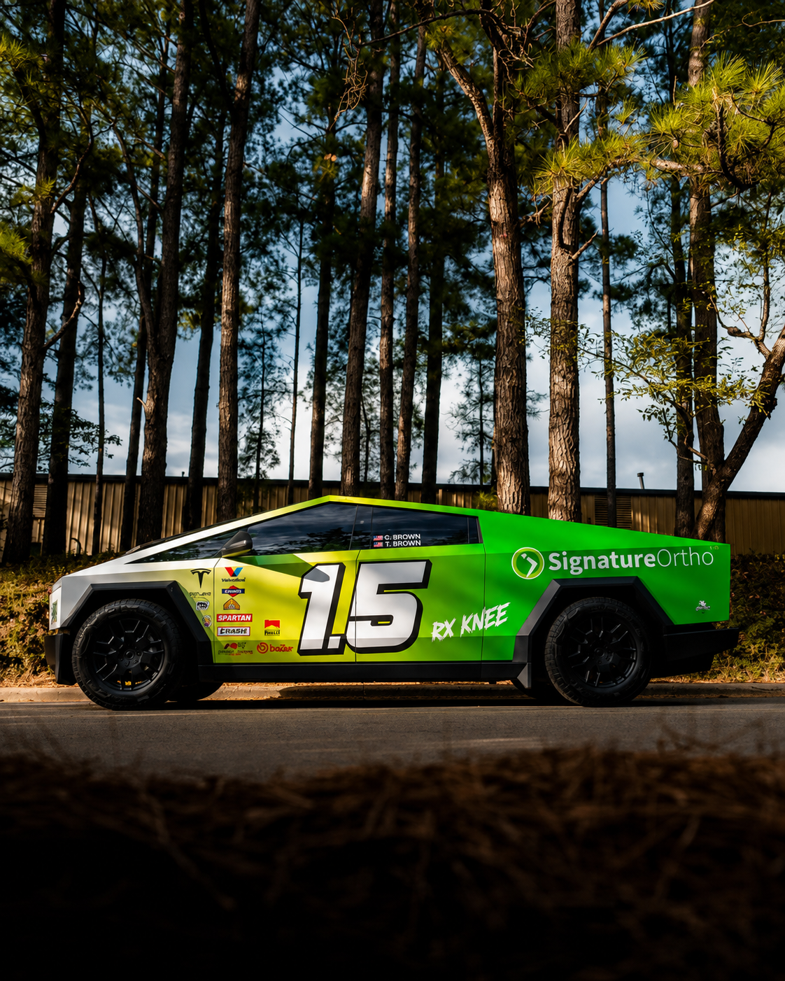 Tesla Cybertruck with custom racing vinyl wrap and sponsor graphics