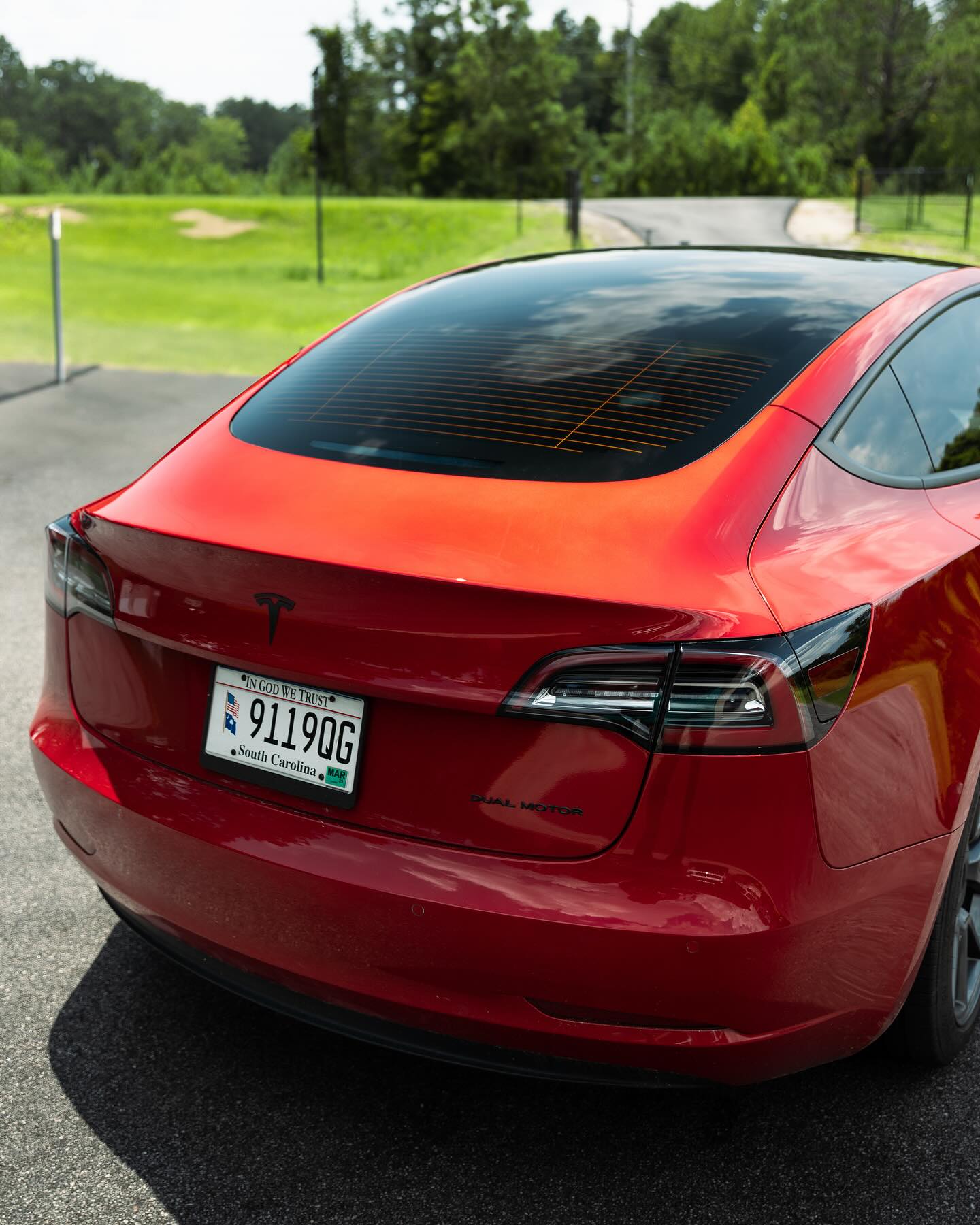 Red Tesla Model 3 with a deep gloss ceramic coated finish in Elyria, Ohio