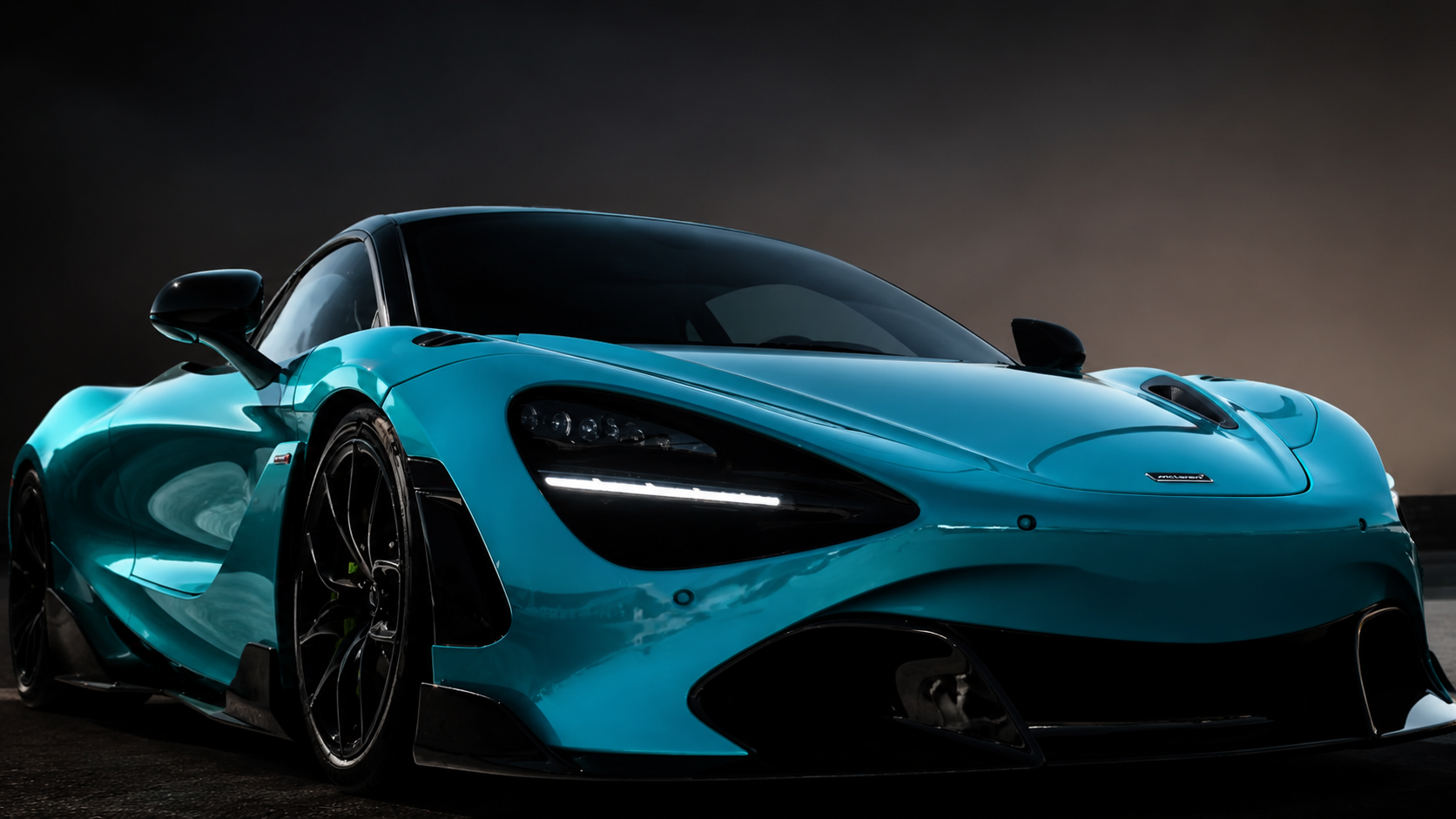 McLaren 720S in a gloss teal blue color change wrap