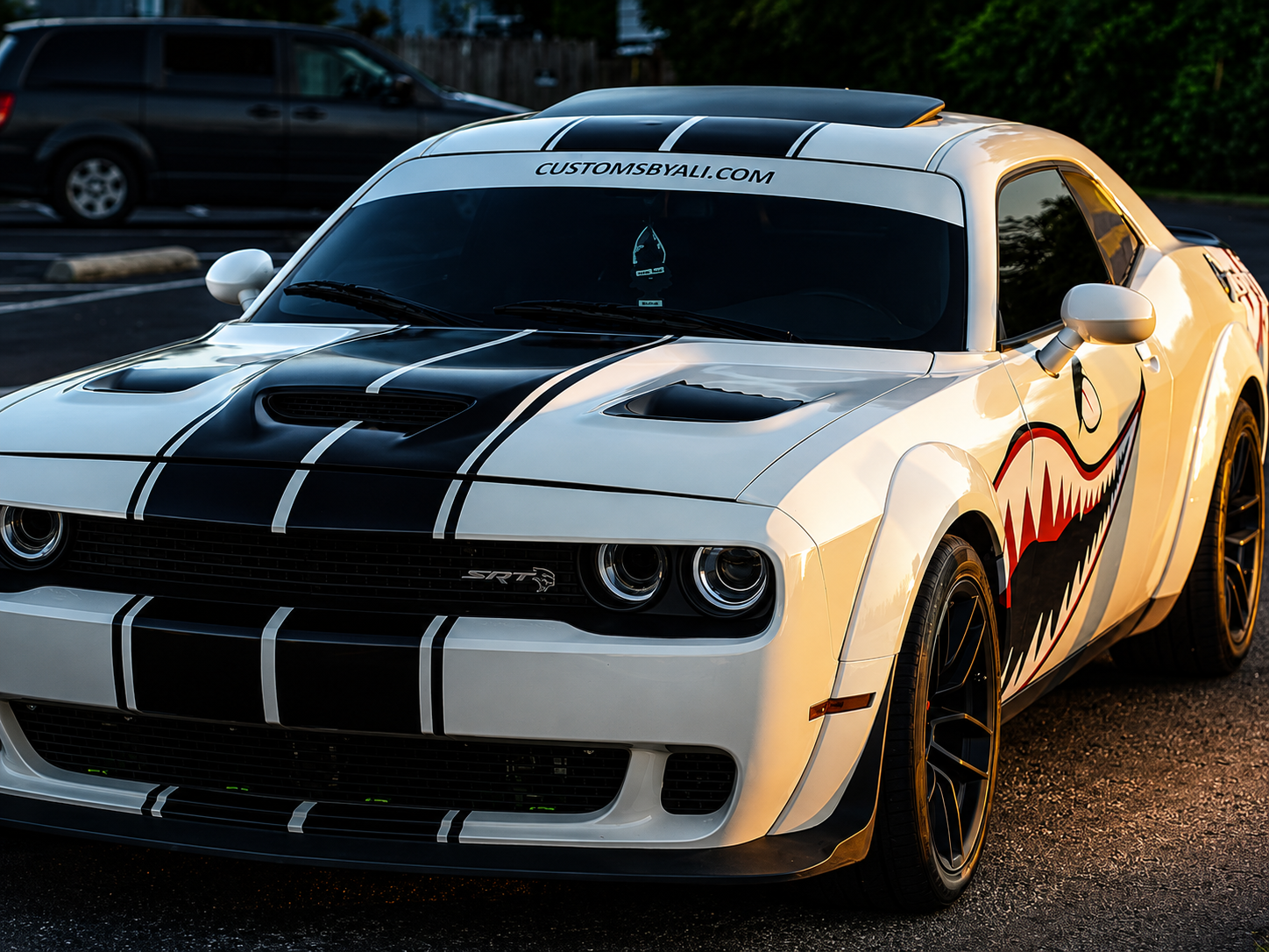 Dodge Challenger with bold black racing stripes and custom shark mouth graphics by CustomsByAli in Elyria, OH