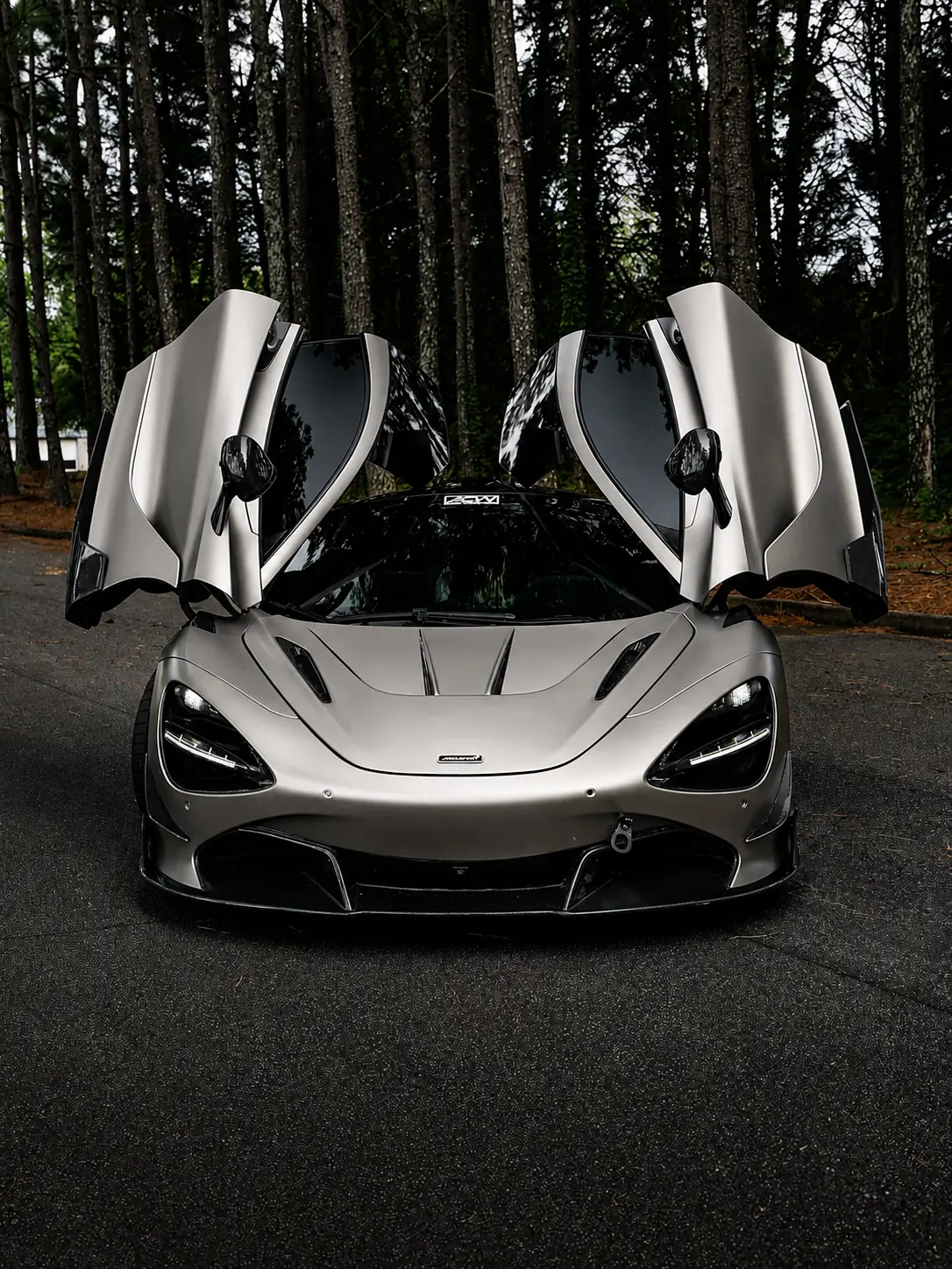 Satin grey McLaren 720S with doors up after a full color change wrap